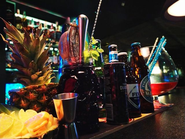 Bar tools, fresh fruit and bottles lined up on the Cozy bar