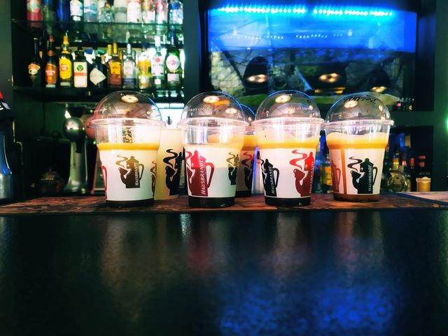 Take-away coffees lined up on the bar at Cozy