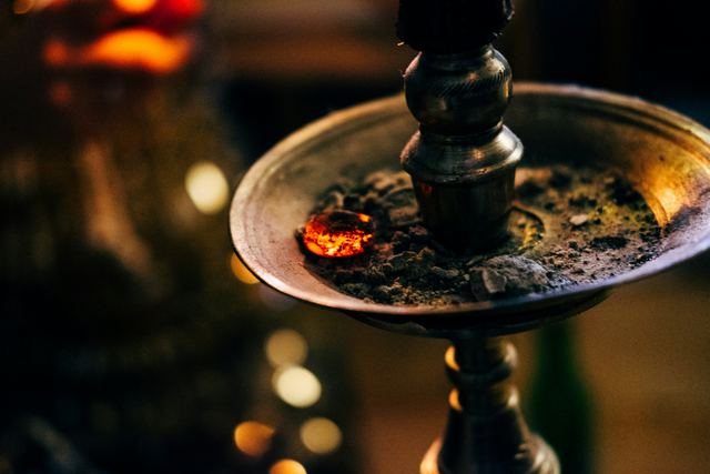 Close-up of a glowing coal on a hookah tray